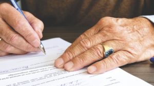 signing a contract and check shows commitment principle