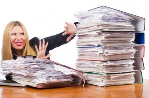 woman with pile of papers