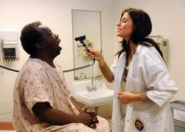 nurse practitioner examines patient