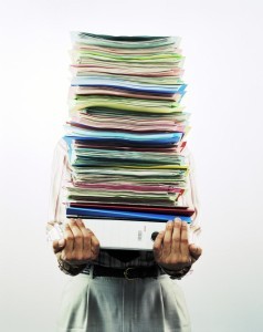 person carrying stack of medical records