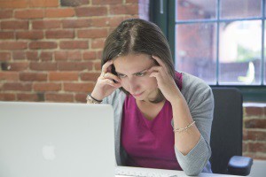 image of woman staring at computer for Webinar FAQs