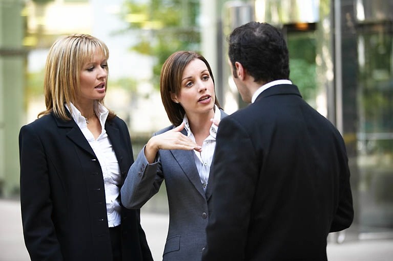 two women talking to a man