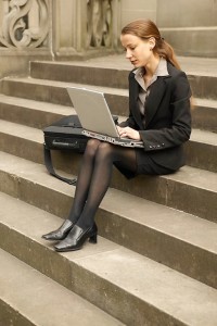 woman looking at computer on stairs