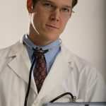 young doc image of physician holding a computer