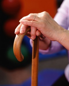 woman's hands on cane