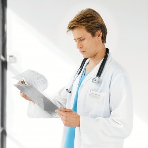 physician looking at medical record